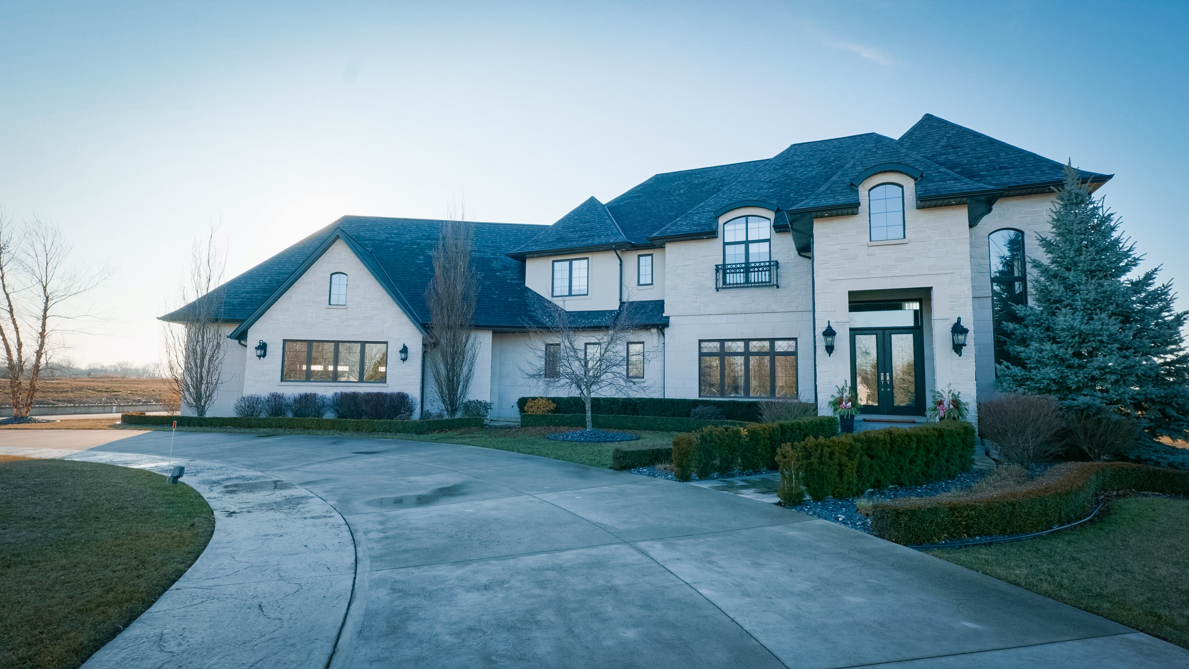 French country custom home at dusk