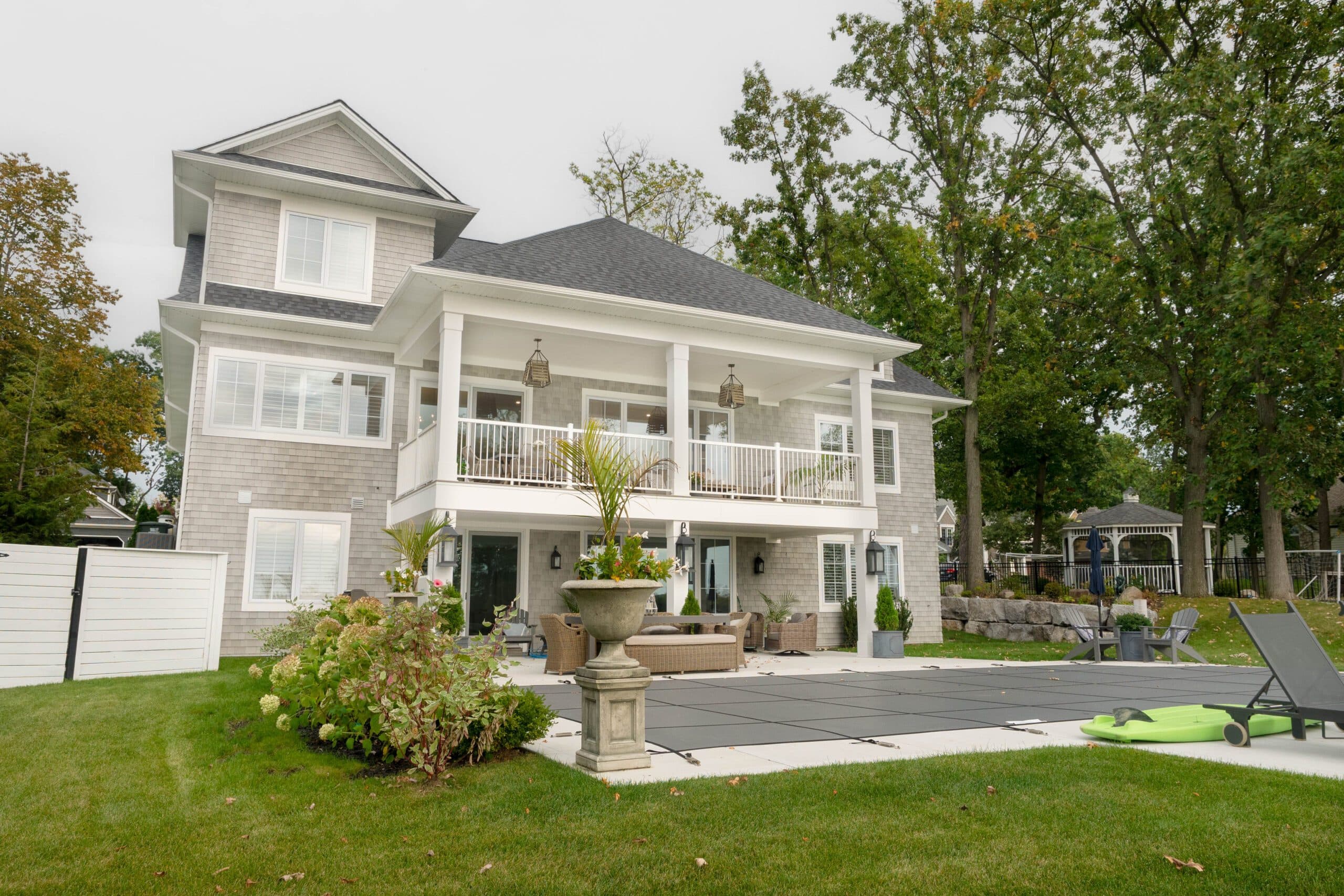 Waterfront custom home with covered balcony and patio by Timberland Homes in Amherstburg, Ontario.